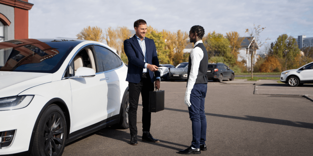 Two men shaking hands beside a white cab, symbolizing a successful agreement or professional service.